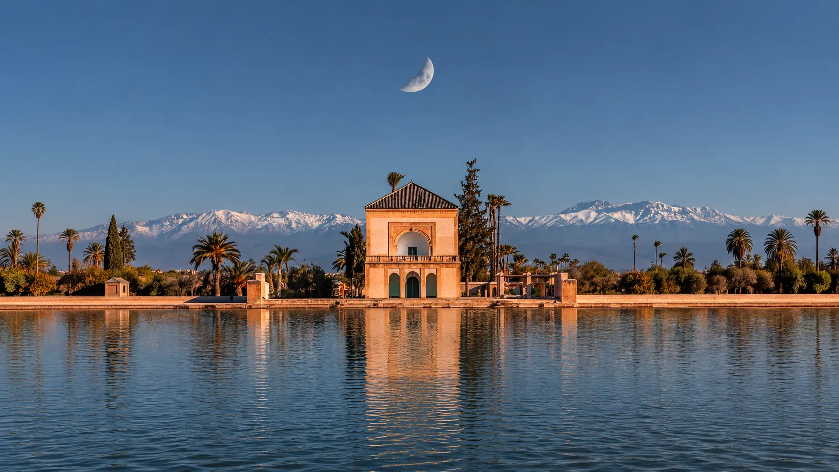 The Menara pavilion and its pool in Marrakech, the snowy Atlas behind