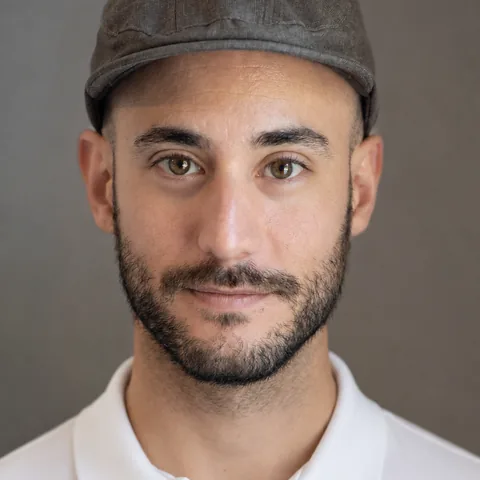 Sergio, in a cap and a white polo